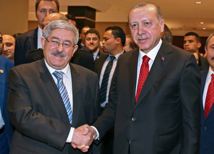 Turkish President Recep Tayyip Erdogan shaking hands with Algeria's Prime Minister Ahmed Ouyahia
