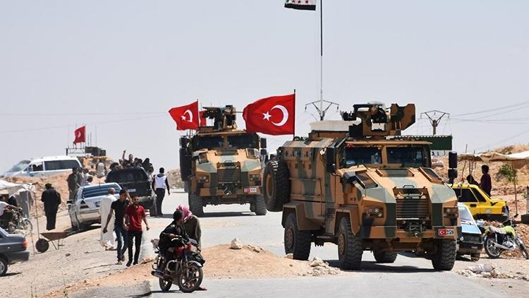 Turkish armored vehicles patrol in rural Manbij