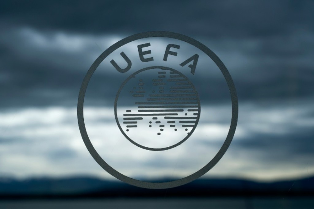 UEFA logo on a dark cloudy background.