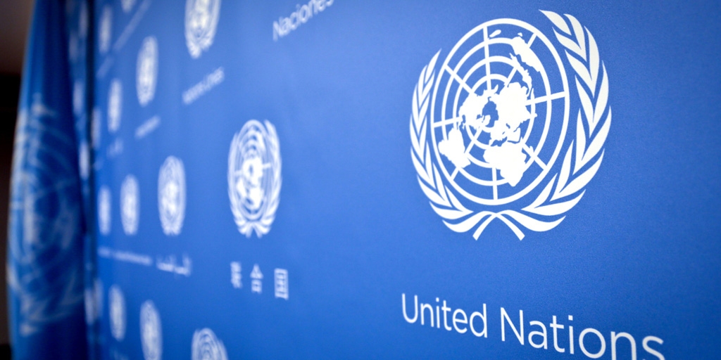 A wall decorated with United Nations (U.N.) logo.