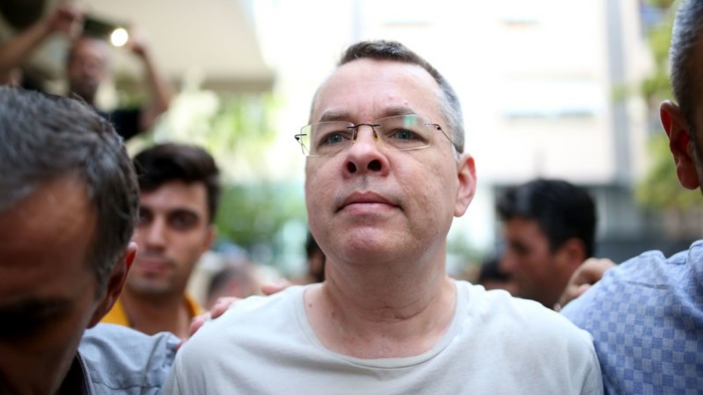 U.S. pastor Andrew Brunson walking with two police officers.