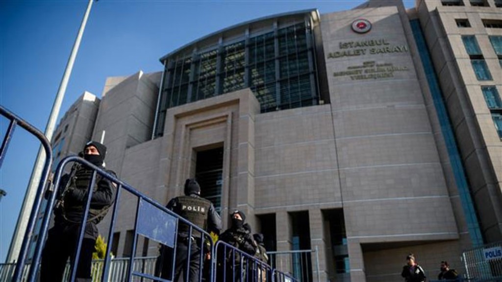 Two police officers standing guard outside an Istanbul courthouse.