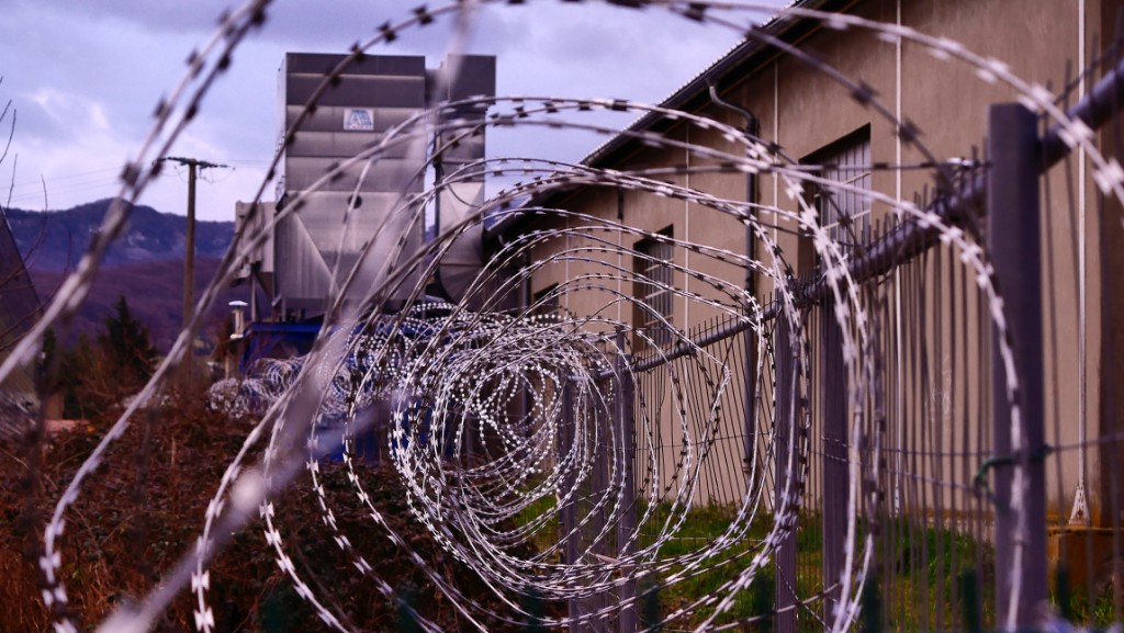 Barbed wire around a prison building.