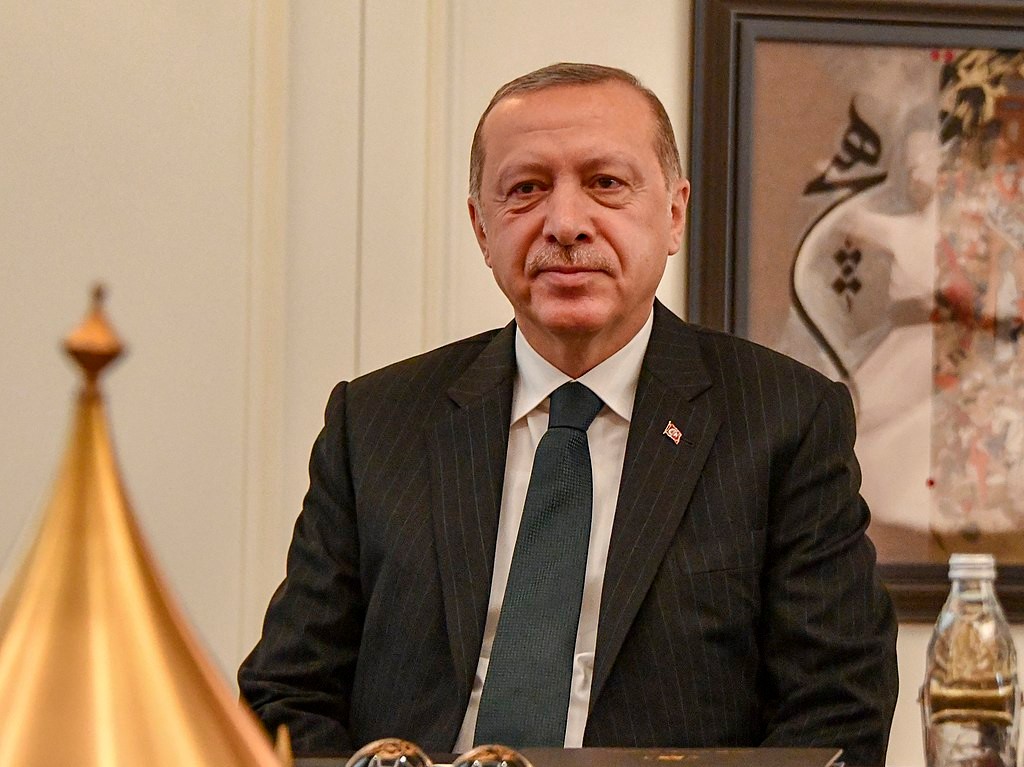 Turkish President Recep Tayyip Erdogan sitting in a chair.
