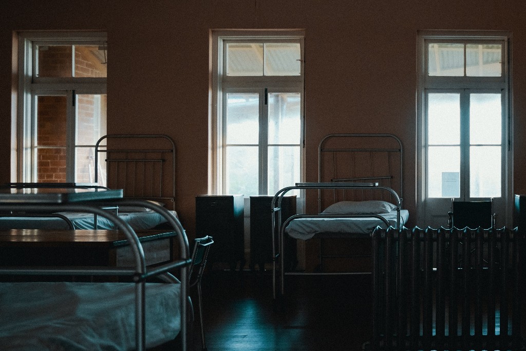Several hospital beds in a dark room